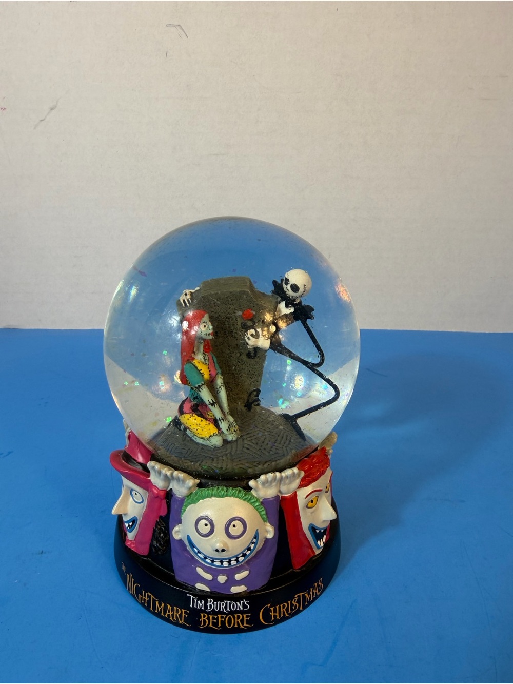 Disney collectible base with black logo on white finish